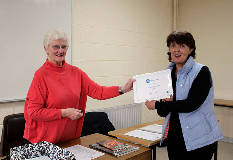 Betty Teahan handing Christina her Certificate