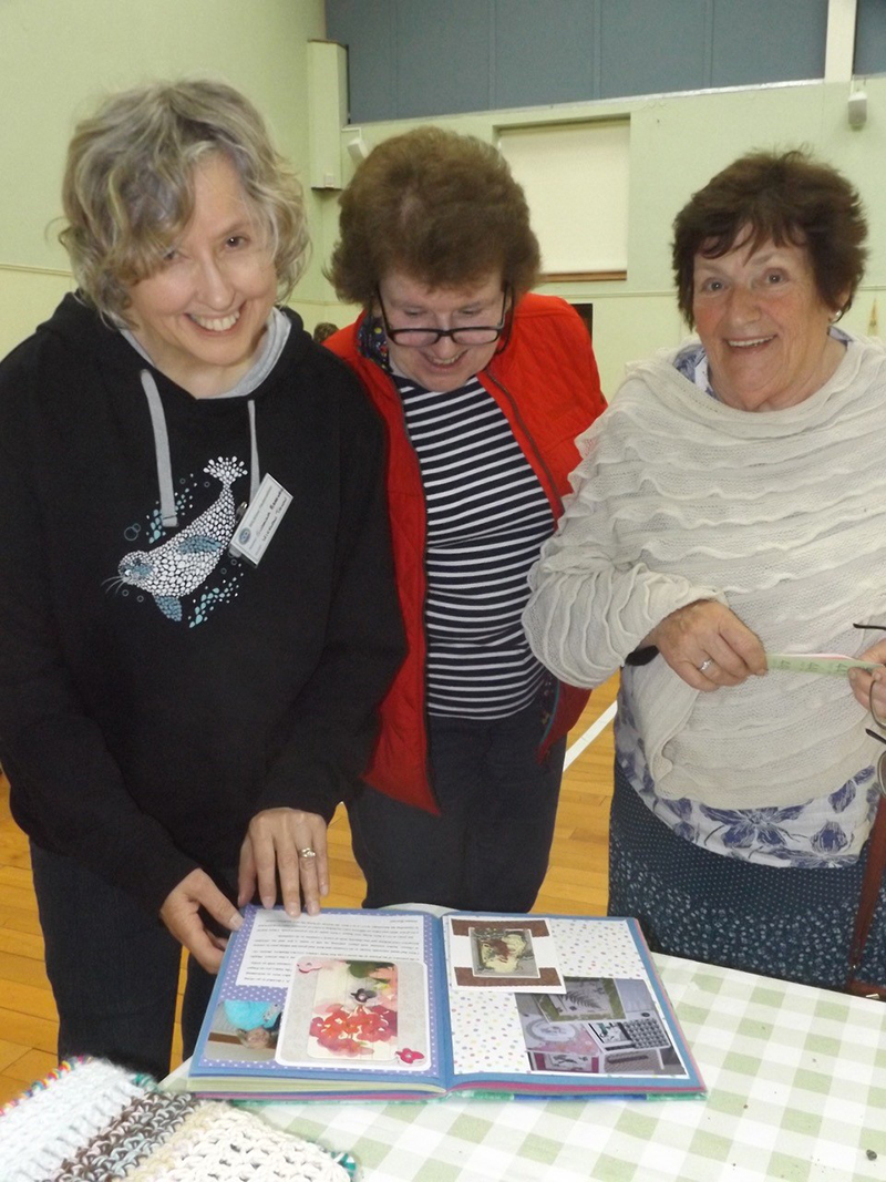 ICA Wicklow Town Guild's Anna Sinnott and Susanna Braswell looking at Bray Guild's yearbook
