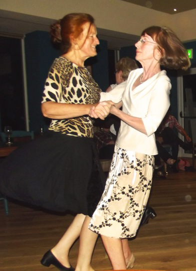 Two Set Dancers from Wicklow Town ICA in a whirling pose